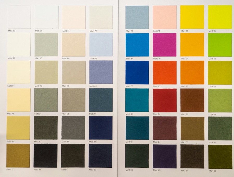 A book of paint colour samples open to a page of swatches